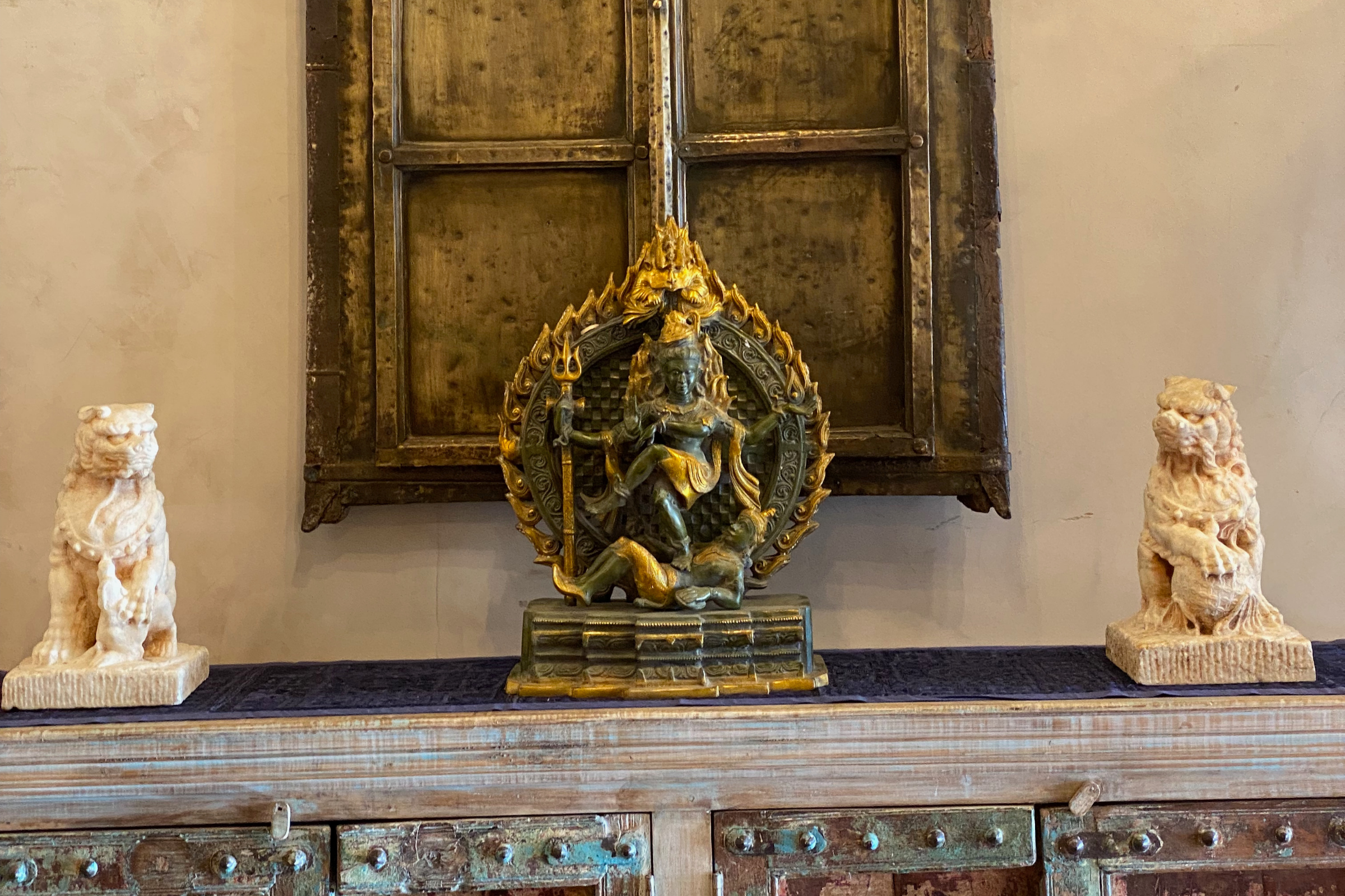 Sculptural statuary styled within a thoughtfully designed interior focused on grounding, balance, and presence.